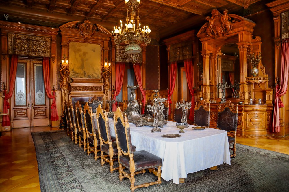 Image of the dining room with a large antique table and chairs around it